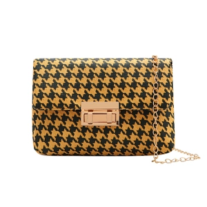 Classic houndstooth handbag with gold metal lock and elegant gold chain strap detail