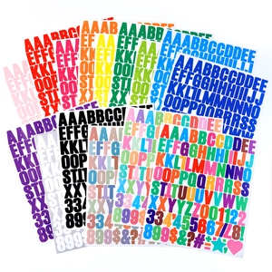 Macro view of colorful 1-inch vinyl letter and number stickers in fan-shaped layout