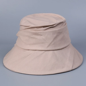 Close-up of beige cotton linen sun hat showing breathable woven texture and pleated design