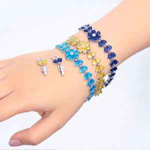 Colorful copper flower bracelets with sparkling cubic zirconia in blue and yellow tones