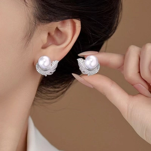 Elegant pearl feather earrings featuring white pearls and zircon-encrusted silver leaf