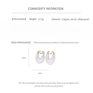 Detail view of pearl earrings with copper base and zircon, showing 13.1g weight and size