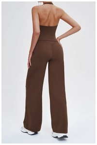 Rear view of brown backless halter yoga top and high-waisted wide-leg sports pants