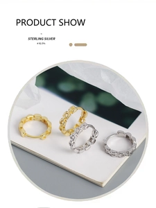 Detail of S925 sterling silver chain link earrings with inlaid diamonds in gold and silver