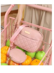 Pink quilted crossbody bag detail with golden hardware and matching round coin purse
