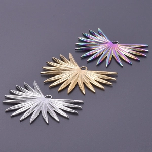 Detailed view of sunburst leaf pendants in silver, gold, and iridescent finishes