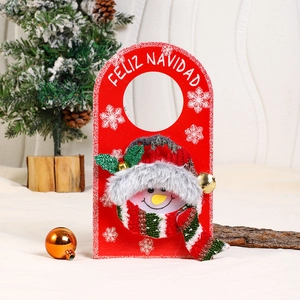 Detail of Christmas snowman door hanger with Feliz Navidad text on red felt fabric