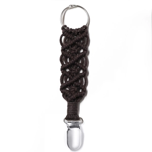 Detail view of a dark brown braided hat clip with a silver metal ring and clasp on white background