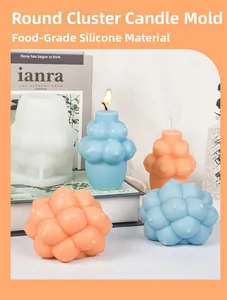 Macro view of food-grade silicone ball mold with finished orange and blue bubble candles