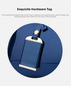 Close-up of golden hardware tag on navy blue patent leather Boston handbag