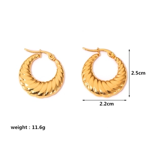 Macro view of gold croissant earrings showing 2.5cm height and spiral texture details