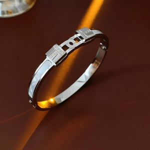 Detailed macro view of silver titanium steel T-shaped bangle with inlaid white mother of pearl