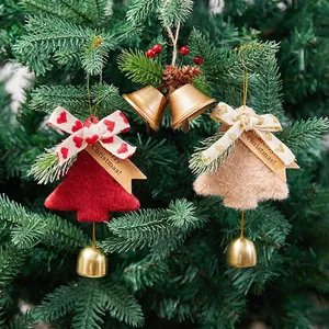 Christmas tree hanging felt bells with red and beige bows and pine cone decorations