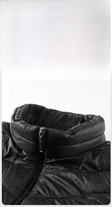 Detail of black stand-up collar with horizontal quilting and metal SPORT zipper