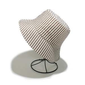 Detail of striped sun hat featuring breathable eyelets and a classic bucket shape