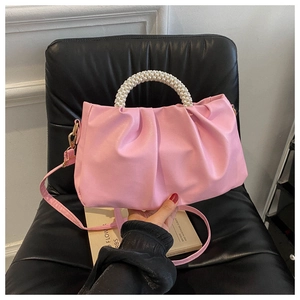 Detailed view of pink pleated cloud bag with white pearl handle and PU shoulder strap