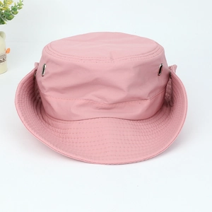 Detail of pink hiking hat featuring metal eyelets and reinforced stitching on the brim