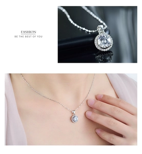 Detail view of a classic round cut solitaire pendant necklace on a 925 sterling silver chain