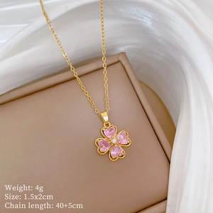 Close-up of pink zircon clover necklace with golden chain and product dimensions details