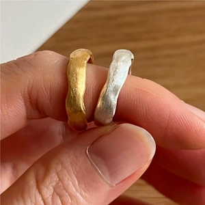 Detail of matte brushed texture on sterling silver rings in gold and silver finish