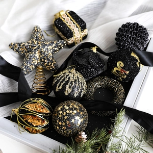 Elegant black and gold Christmas ball ornaments set with glitter and star tree topper
