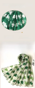 Detailed macro view of soft green clover print scarf with breathable lightweight fabric