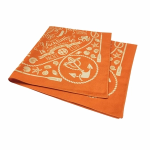 Close-up detail of orange cotton bandana featuring cream nautical anchors and starfish prints