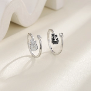 Detailed macro view of silver open rings with black and white guitar designs