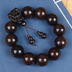 Handcrafted ebony wood bead bracelet with PiXiu charm and gourd pendants on blue background