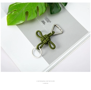 Close-up of military green woven lanyard with silver triangle clasp and key ring detail