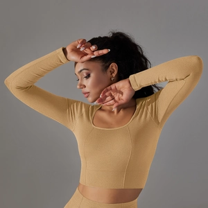 Detailed macro view of honeycomb knit fabric texture on yellow long sleeve yoga top