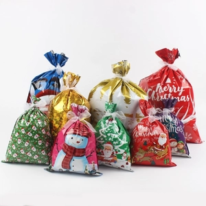 Detail of Christmas drawstring gift bags in multiple sizes with Santa and elk patterns