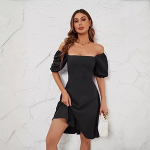Elegant black square neck puff sleeve dress with a slimming silhouette and gold accessories