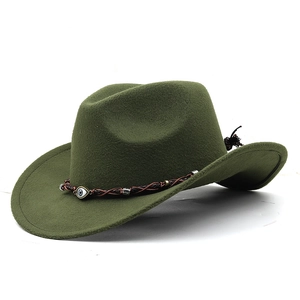 Detail of olive green cowboy hat with woven leather band and evil eye pendant charm