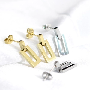 Detail of 18K gold and silver hollow rectangular earrings with dual-loop nested structure