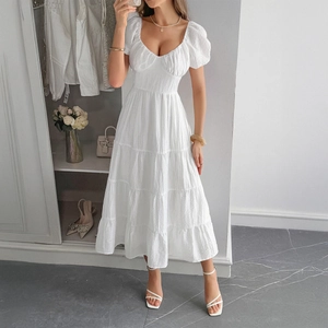 Elegante abito bianco con maniche a sbuffo, vita aderente e gonna a balze per l'estate