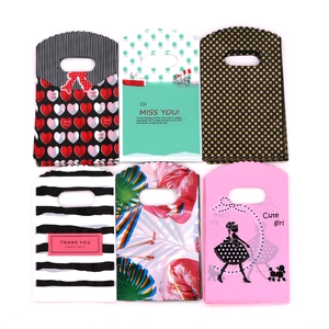 Macro shot of 9x15cm mini plastic gift bags with heart and palm leaf prints