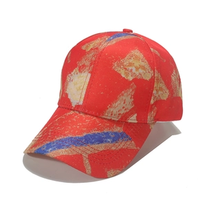 Colorful graffiti baseball cap with red base and artistic yellow and blue paint stroke print