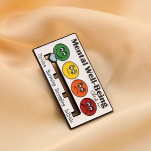 Macro view of a mental well-being check-in enamel pin with a sliding status bar