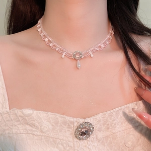 Detail of pink crystal beaded choker with white teardrop pendants on model's neck