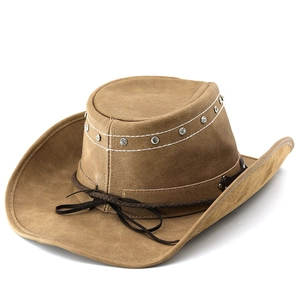 Detail of suede cowboy hat with rhinestone trim and decorative braided rope cord