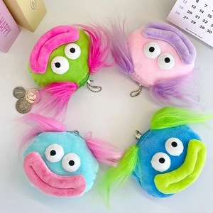 Close-up of colorful plush cartoon coin purses with metal chains in four bright colors