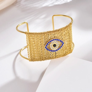 18K gold-plated titanium steel woven open bangle featuring a crystal evil eye charm