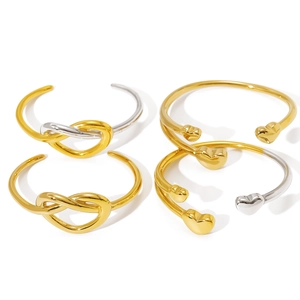 Minimalist gold plated stainless steel open bangles with knot and heart designs in a set