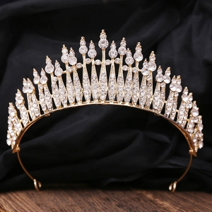 Close-up of golden bridal tiara with sparkling round and teardrop rhinestones