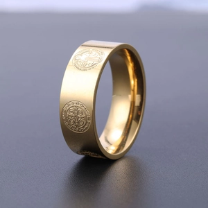 Macro side view of gold St. Benedict Medal ring with vintage religious engraving detail