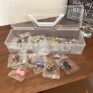 Portable transparent jewelry box with handle and sealed bags for earring storage