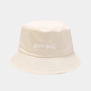 Close-up of beige cotton bucket hat featuring white Night Call script embroidery