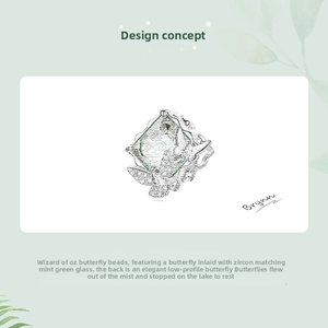 Detail showing mint green glass butterfly charm with zircon stones and hollow-out back