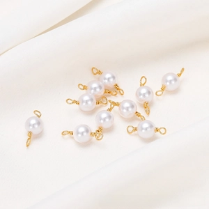 Macro detail of 18K gold-plated pearl connectors for DIY jewelry making and handcrafts
